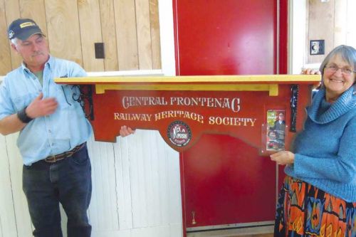 Rodger MacMunn and Sally Angle, on behalf of the Central Frontenac Railway Heritage Society, present Council with a display shelf